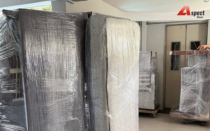 Aspect Mover transporting wrapped furniture in an elevator lobby.