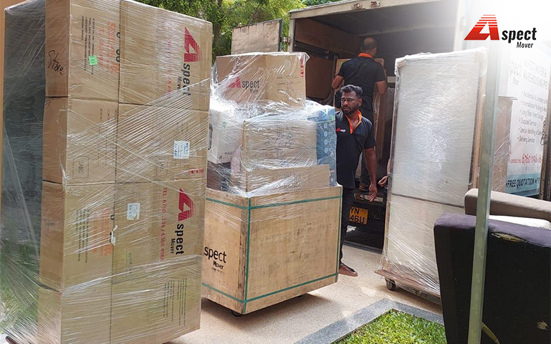 Professional movers loading a moving truck with boxes and furniture.